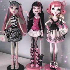 three dolls are standing next to each other