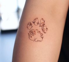 a woman's arm with a small tattoo design on the back of her left arm