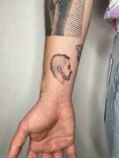 a man's hand with a tattoo on it and a bear head in the middle