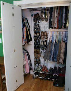 a closet filled with lots of shoes next to a table