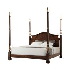 a bed with four posts and white sheets