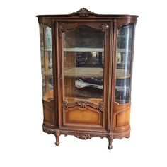 an antique china cabinet with glass doors