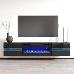 an entertainment center with a television and blue flames on the front, in a living room