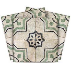 four pieces of white and green tile with an intricate design on the front, back and sides