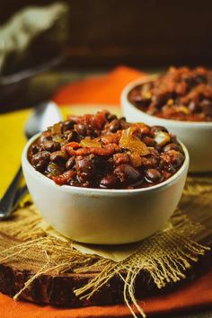 two white bowls filled with chili and beans