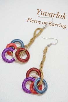 the earrings are made with multicolored yarn