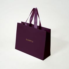 a purple shopping bag with the word sample on it's front and side handles