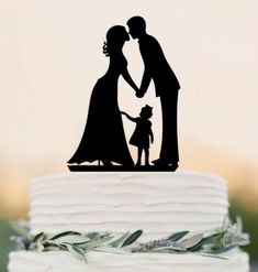 a wedding cake topper with a silhouette of a bride and groom holding each other's hand