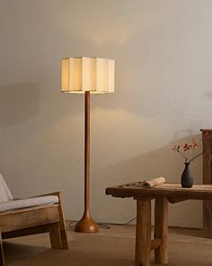 a living room scene with focus on the floor lamp and table in the foreground