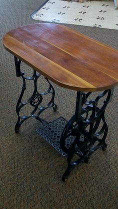 a wooden table sitting on top of a carpeted floor