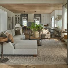 a living room filled with furniture and lots of windows