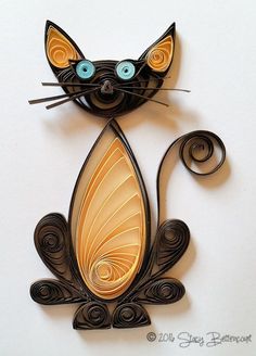 a paper sculpture of a cat with blue eyes on it's head and tail