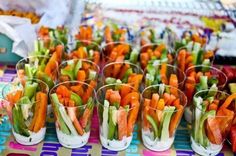 carrots and celery are arranged in small cups