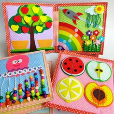 four colorful cards with pictures of fruit and vegetables on them, one is made from felt