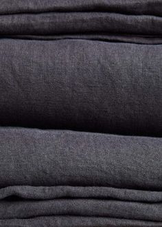 folded dark grey linens on top of each other