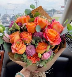 a bouquet of flowers sitting on the dashboard of a car