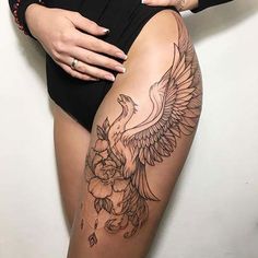 a woman with tattoos on her thigh and leg