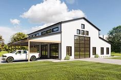 a white truck is parked in front of a large garage with windows on the side