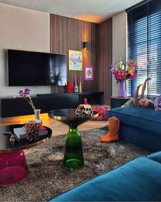 a living room filled with furniture and a large flat screen tv mounted on the wall