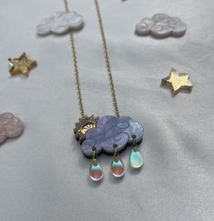 These cute celestial cloud necklaces will brighten up any day, rain or shine! This necklace features an adorable pearlized raincloud with engraved detail and a glitter and mirrored gold sunbeam! We have also added our new autumn skies sunbeam necklace in a pink, glittery tone. You can then choose to add the Iridescent raindrops for an extra sweet feature. The pendant measures 3cm in width which makes it wearable for all occasions and is complimented with a gold plated adjustable chain. Each one is lovingly made and designed in my home studio and will arrive in a presentation box and gift wrapped. Cute Jewellery, Cloud Necklace, Necklace Cute, Celestial Necklace, Rainbow Necklace, Rain Or Shine, Moon Necklace, Rain Drops, Beautiful Gift Boxes