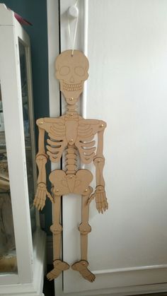 a wooden skeleton hanging from the side of a door