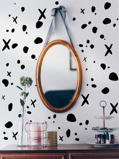 a mirror hanging on the wall next to a dresser