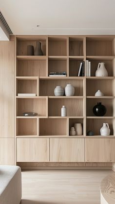 a living room filled with lots of wooden shelves