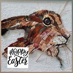 an animal made out of mosaic tiles with the words happy easter on it