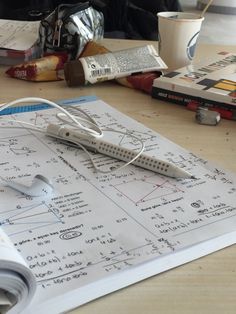 a table with some papers and headphones on it