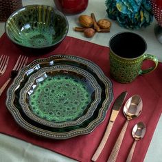 a place setting on a table with silverware