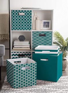 three storage bins with different patterns and designs on them, one is blue and the other is green