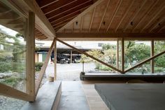 the inside of a wooden building with stairs leading up to an open area in front of it