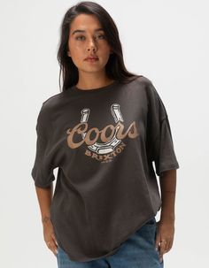 Brixton X Coors Oversized Tee. Large Graphic Screened On Front. Oversized Fit. Crew Neck. Short Sleeve. 100% Cotton. Machine Wash. Imported. Model Is Wearing A Size Small. Model Measurements:height: 5'7" Bust: 34"waist: 25"hips: 34.5" Womens Oversized Tee, Flannel Sweatshirt, Graphic Trends, Boys Graphic Tee, Girls Graphic Tee, Girls Blouse, Loose Jeans, Top Graphic Tees, Puff Sleeve Top