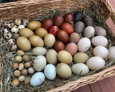 a basket filled with lots of different colored eggs