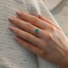 Presenting our vintage emerald and diamond three stone ring. Featuring an enchanting 1.3 carat emerald flanked by two emerald-cut diamonds, it's a classic piece radiating sophistication. Available in 18K Yellow Gold Available in a size 7 Ring can be resized between sizes 6-8 for an additional fee. Please contact our team at info@stephaniegottlieb.com for more information. Green Emerald weight = 1.30 carats Diamond weight = 0.43 carats Diamond quality = FG color, VS clarity Origin = Germany Estim Timeless Emerald Ring With Radiant Cut, Green Emerald Ring With Three Stone Baguette Cut, Green Three-stone Emerald-cut Emerald Ring, Green Three Stone Emerald Cut Emerald Ring, Three-stone Emerald Cut Green Emerald Ring, Green Baguette Cut Three Stone Emerald Ring, Green Emerald Cut Three Stone Emerald Ring, Radiant Cut Emerald Ring With Prong Setting For Proposal, Radiant Cut Emerald Ring For Proposal