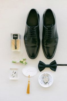 the groom's accessories are laid out neatly on the floor for his wedding day