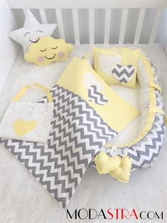 a baby crib bedding set with yellow, gray and white chevrons