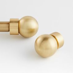 two gold door knobs on a white background