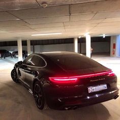 a black sports car parked in a parking garage