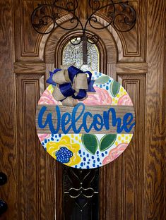 a welcome sign hanging on the front door