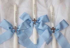 three toothbrushes with blue ribbons tied around them