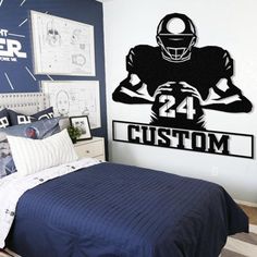 a bedroom with a football player decal on the wall and bed in front of it