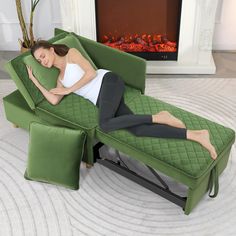 a woman laying on a green couch with her arms resting on the back of it