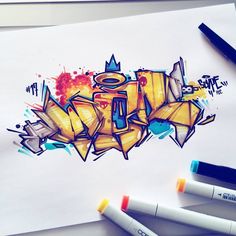 a piece of paper with graffiti on it and markers next to it, all in different colors