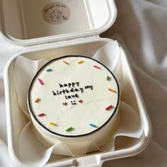 a birthday cake in a foam container with writing on it