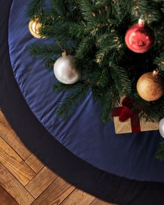 a christmas tree skirt with ornaments on it