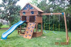 a wooden playset with a blue slide