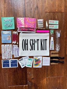 an assortment of personal care items laid out on a wooden floor with the words oh shitt kit