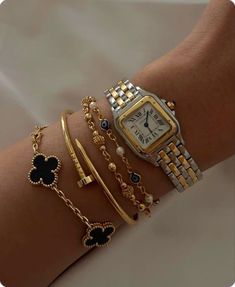 a woman's arm with bracelets and watches on it