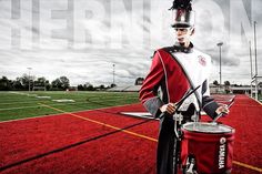 a man in a marching uniform walking on a field with a bagpipe and pipe